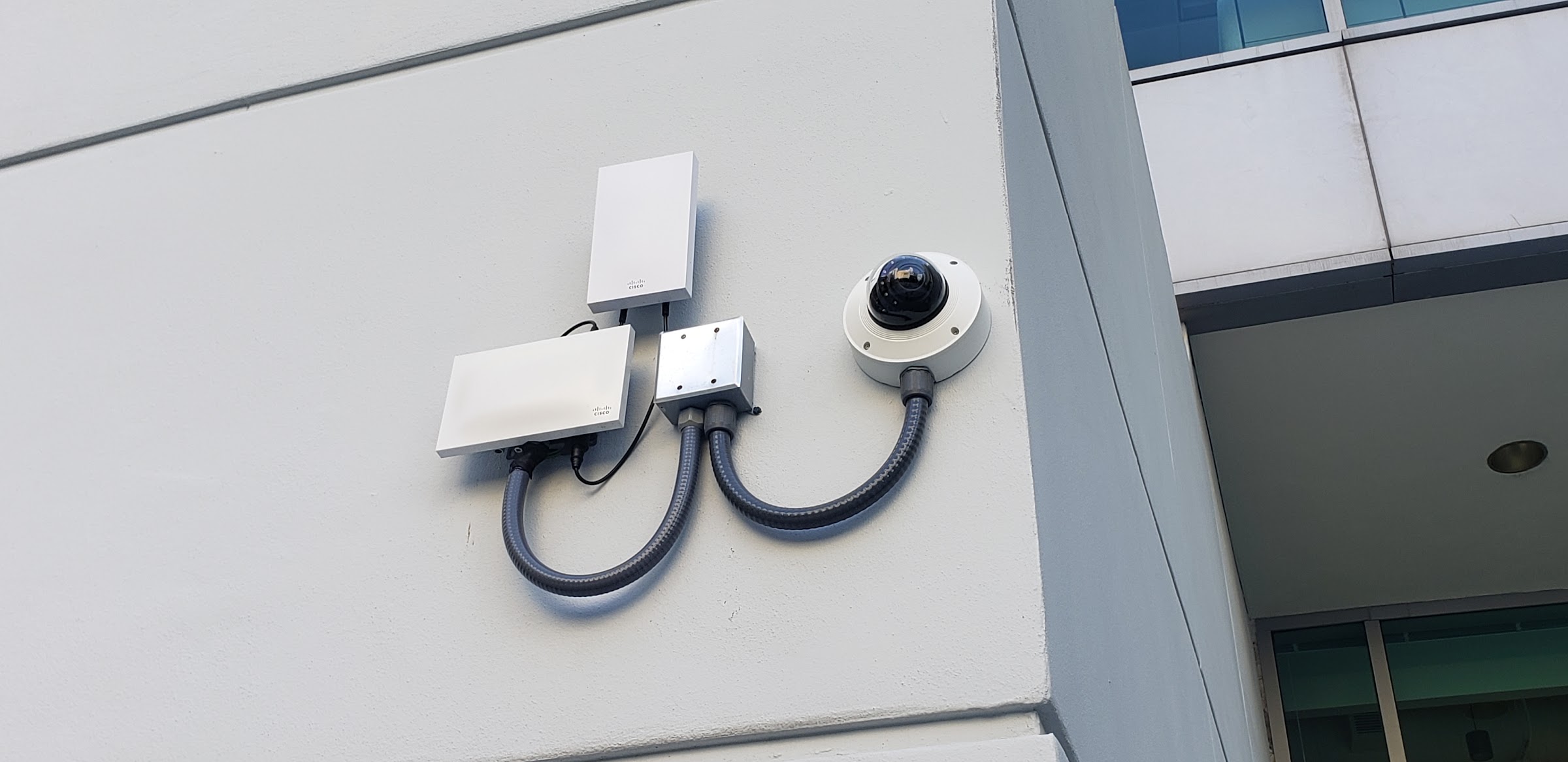 Dome camera and wireless links on an exterior wall